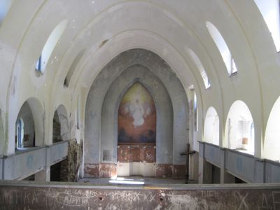 Lumivaaran kirkon alttaritaulu kuvattu takaparvelta. Alttaritaulu on maalattu seinään.
